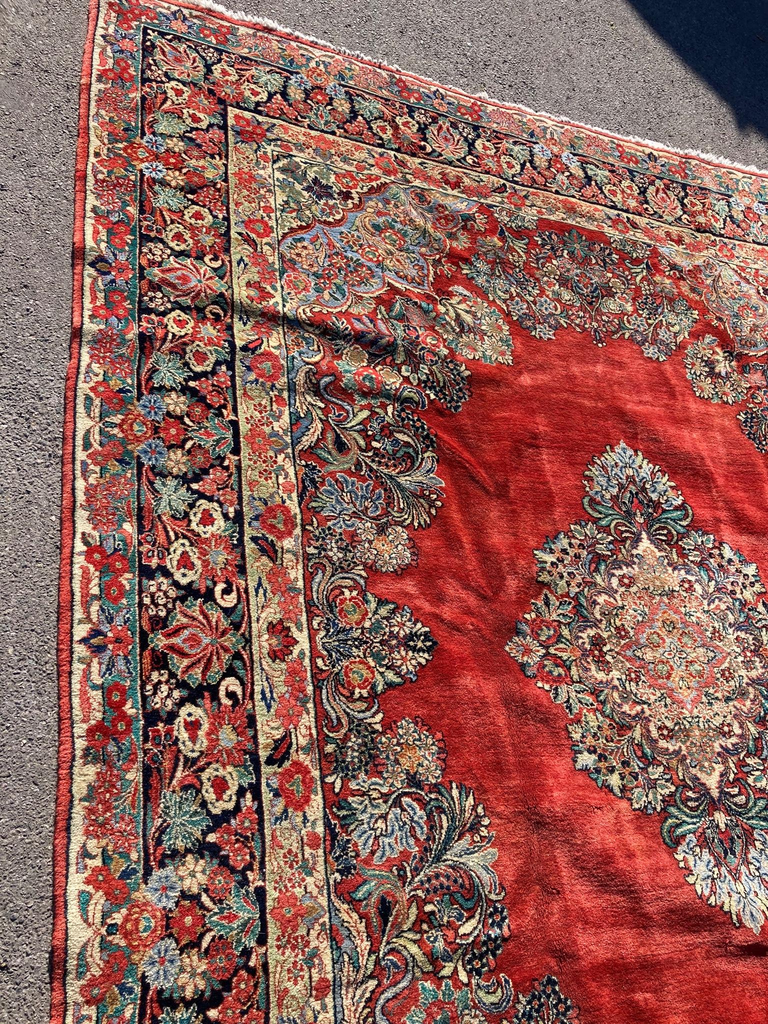 A large North West Persian red ground carpet, 361cm x 274cm